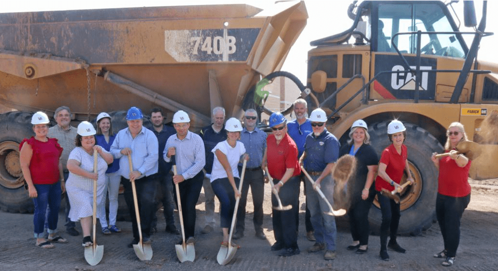 Movin' earth for water, photo of group getting ready to break ground to start project